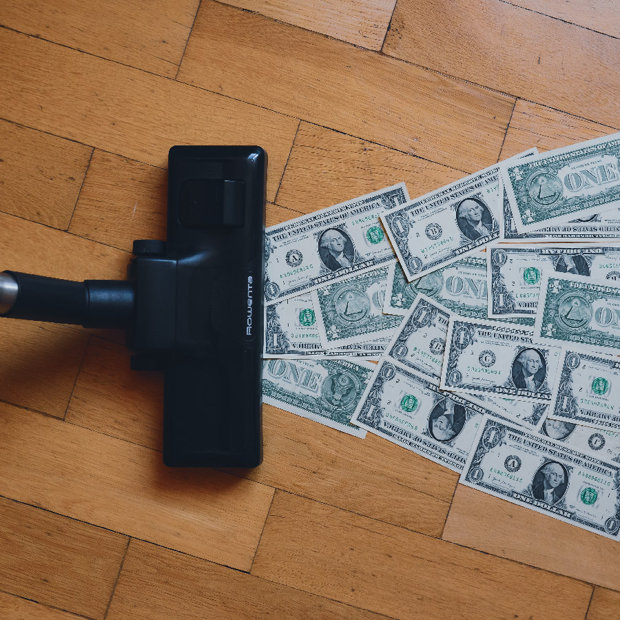 Vacuum sucking up dollar bills